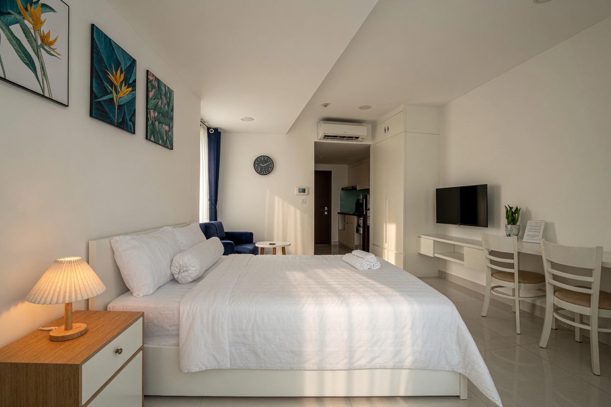 RiverGate studio with bed, work desk, smart TV and warm bedside lighting